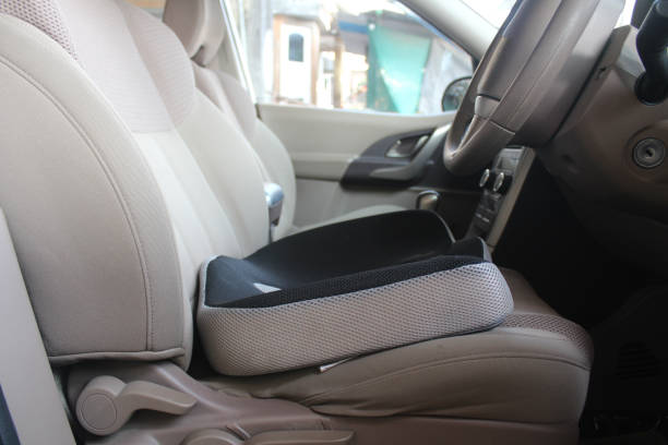 Coccyx memory foam seat cushion Coccyx memory foam cushion in car driver seat coccyx photos stock pictures, royalty-free photos & images