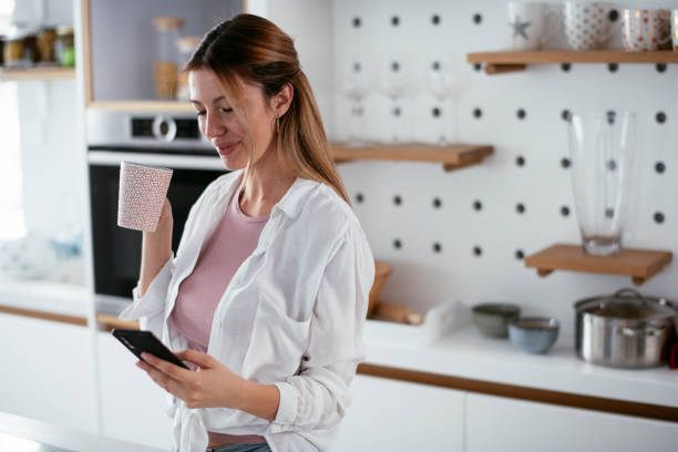 istock eautiful woman preparing breakfast and using the phone. 1279140236