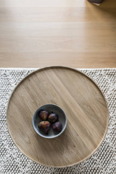 Coffee table with figs A wooden round coffee table with bowl full of figs. coffee table stock pictures, royalty-free photos & images