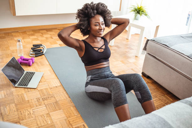 istock Young smiling athletic woman doing sit-ups at home. 1279140785
