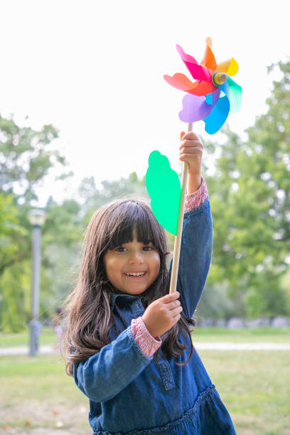 istock Happy black haired girl playing in park 1279141492