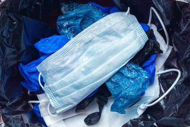 istock thrown out, discarded medical gloves and protective masks in the trash bin after quarantine 1279142188
