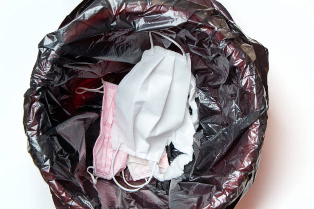 istock thrown out, discarded medical gloves and protective masks in the trash bin after quarantine 1279142191
