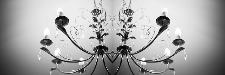 Symmetrical reflection, kaleidoscope of chandelier. Black and white abstract background.