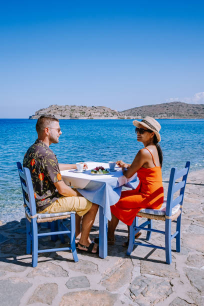 istock Plaka Lassithi with is traditional blue table and chairs and the beach in Crete Greece 1279143244