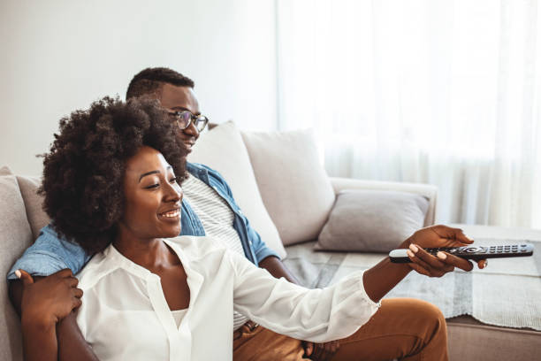 istock Couple at home watching TV. 1279143420