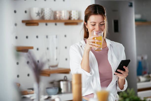 istock Beautiful woman preparing breakfast and drinking juice. 1279143782