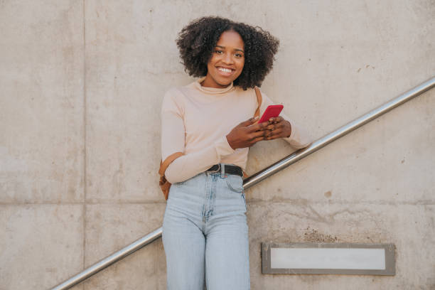 istock Young african american student girl using a smartphone 1279143902