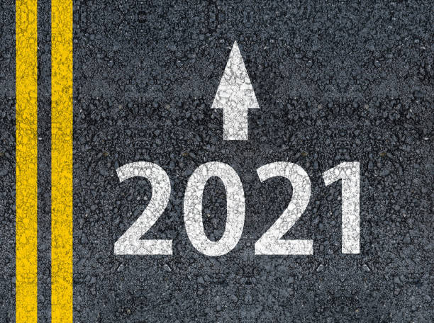 istock Year 2021 and an arrow written on an asphalt road 1279144645