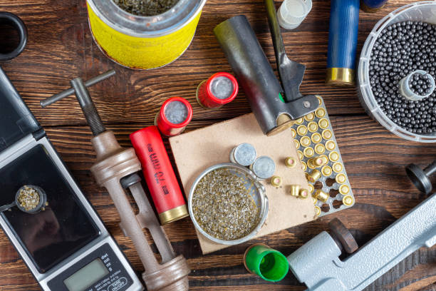 istock reloading process shotgun shells with special reload equipment. Powder, bullets, fraction, shells, buckshot on the wooden background 1279144652