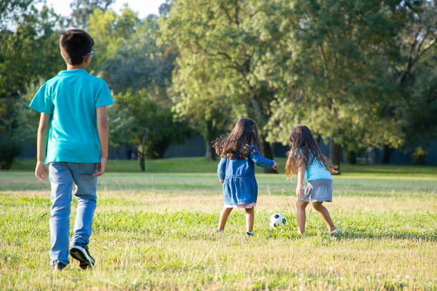 istock Active children playing football on grass 1279144772