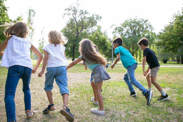 istock Group of active kids having race in park 1279144943