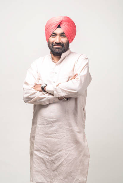 Studio portrait of a sikh handsome man looking at camera with smile