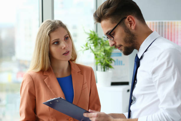 istock Beautiful businesswoman and businessman analyzing documents at work 1279145407