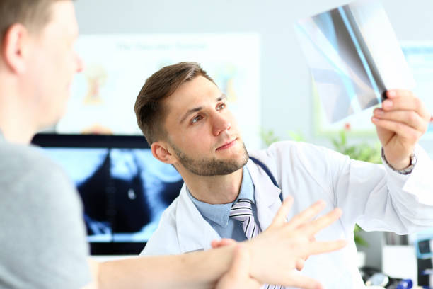istock Handsome young doctor checking X-ray image in clinic 1279145418