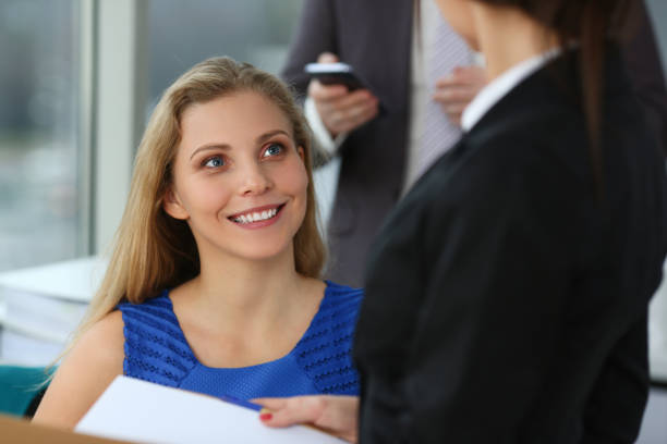 istock Beautiful young woman talking with colleagues at work 1279145466