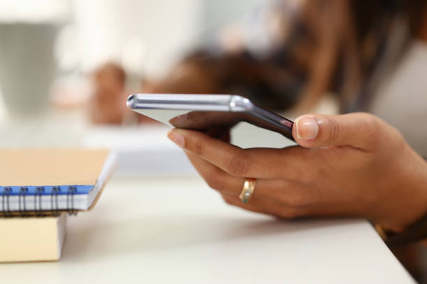 istock Female hand with ring holding mobile phone 1279146451