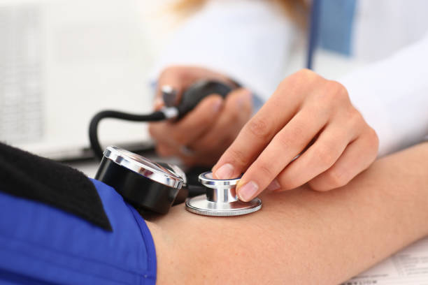 istock Doctor hands examining patient with aneroid sphygmomanometer 1279146654