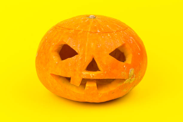 istock Halloween pumpkin head jack lantern on yellow background 1279147136