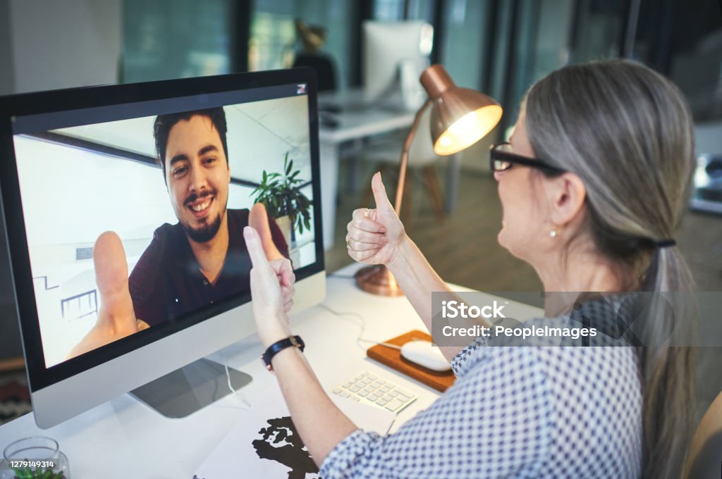 You have the power to control how your story ends Shot of a young man showing thumbs up during an online counselling session with a psychologist Mental Health Stock Photo