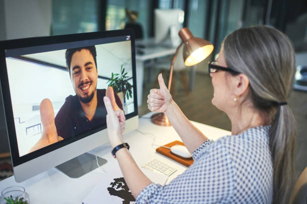 You have the power to control how your story ends Shot of a young man showing thumbs up during an online counselling session with a psychologist guidance support stock pictures, royalty-free photos & images