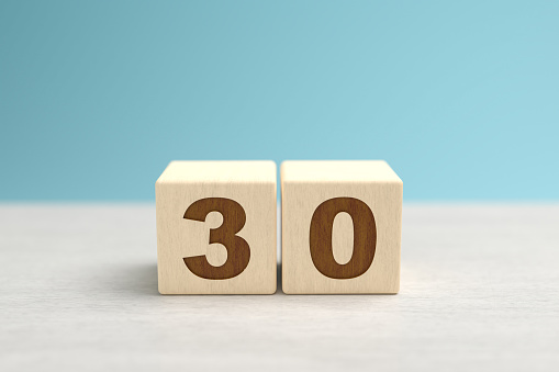 Wooden toy blocks forming the number 30.