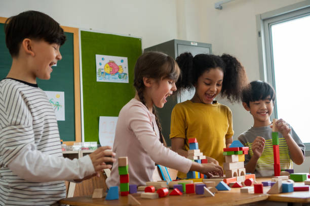 istock Children playing with wooden blocks in classroom 1279151434