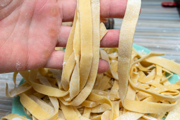 istock Homemade pasta preparation process with hands and rolling pin 1279151679
