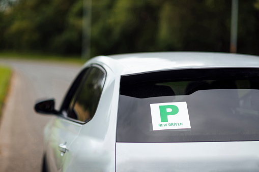 A shot of a P plate on the rear window of a car.