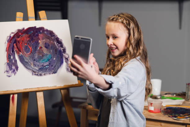 istock a young blogger broadcasts from an art Studio where she draws an abstract picture 1279154771