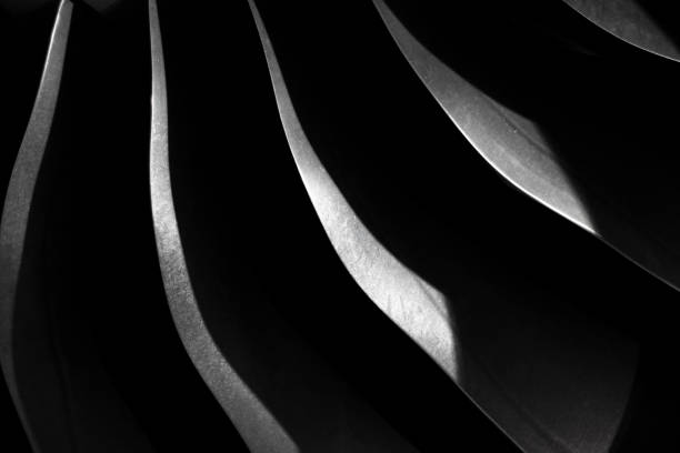 Metallic steel blade on the dark, Aircraft turbojet close up Metallic steel blade on the dark, Aircraft turbojet close up, Black and silver steel abstract texture, modern background with curves and shadow turbojet engine photos stock pictures, royalty-free photos & images