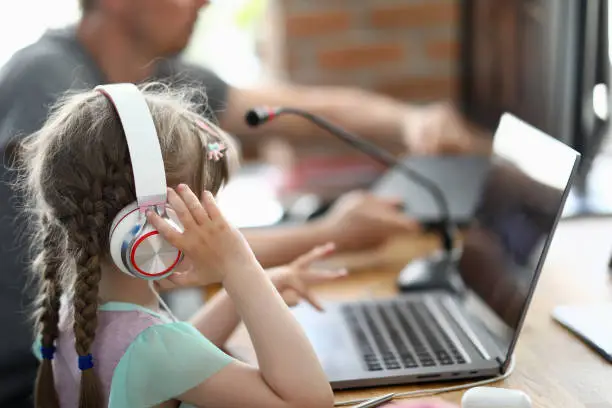 Father with daughter compose a song in home music studio closeup