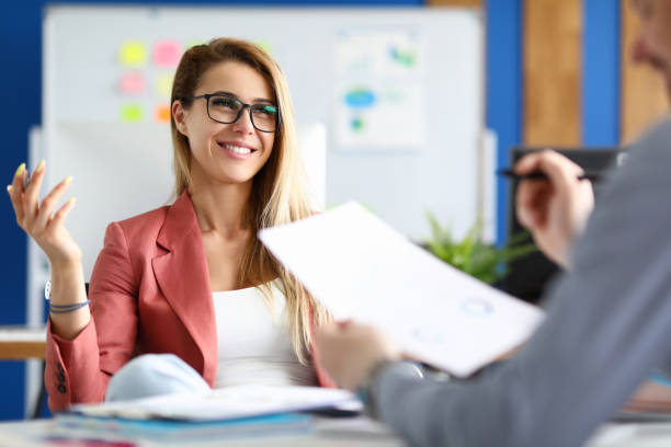 istock Two adult business people make work interview against office background 1279156295
