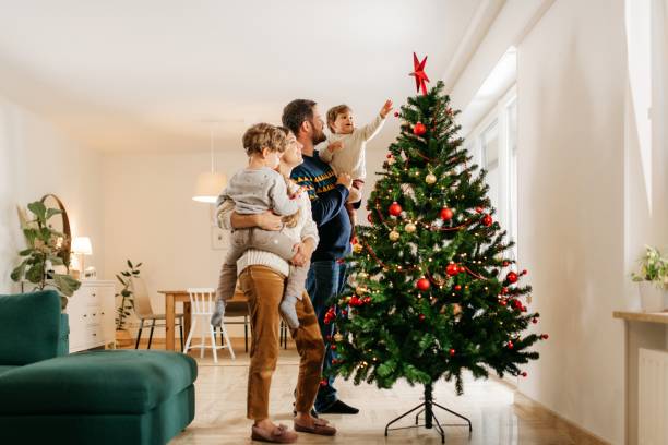 istock Family decorating christmas tree 1279157754