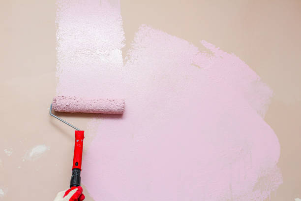 istock painting wall with a roller in pink color 1279157806