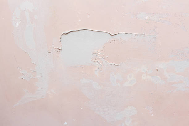 istock Puttying, sealing cracks with gypsum plaster using a spatula. Damaged wall repair. 1279157841