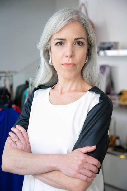 istock Serious Caucasian fair haired woman standing with arms folded 1279157979