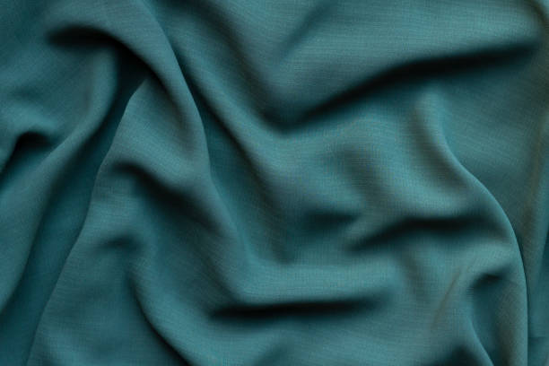 istock Turquoise fabric with large folds texture 1279159099