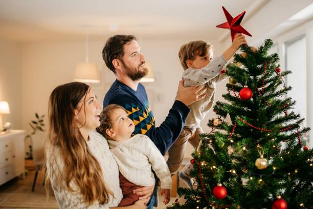 istock Family decorating their christmas tree 1279159457