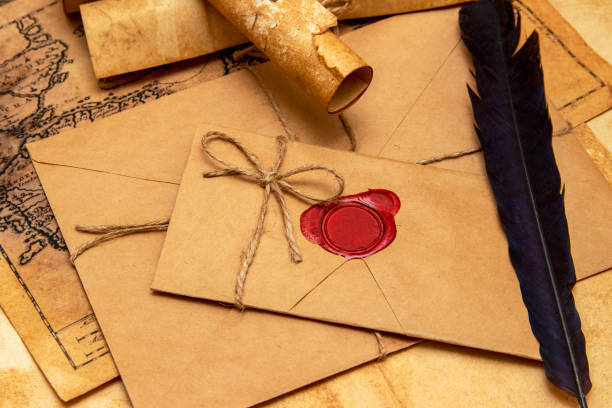 istock The surface of the old wooden table. On the table are old scrolls, an old map, an envelope with a seal, an iron key to the lock 1279160243