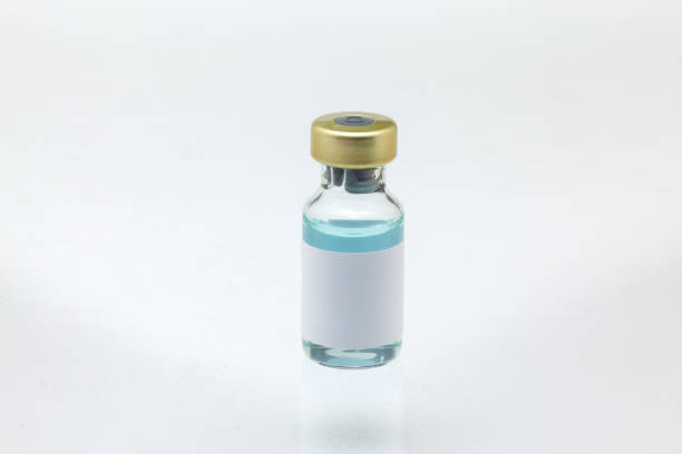 istock Isolated glass vaccine bottle with colored liquid very close high magnification mockup 1279162154