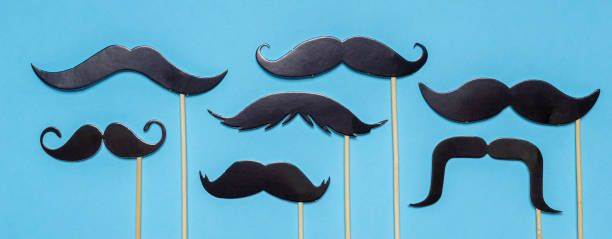 istock Various black photo booth props moustaches of different shape on blue background. Greeting card for father's day or men's health awareness month campaign concept. Flat lay, banner 1279162207