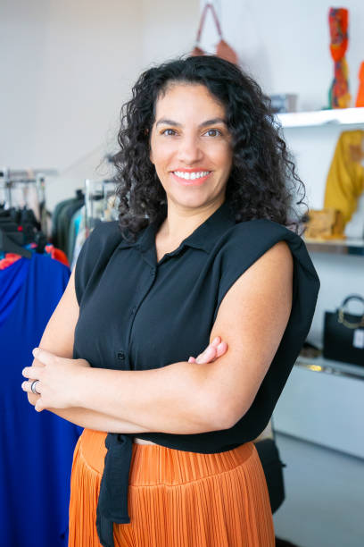 istock Cheerful Latin black haired woman standing with arms folded 1279163550