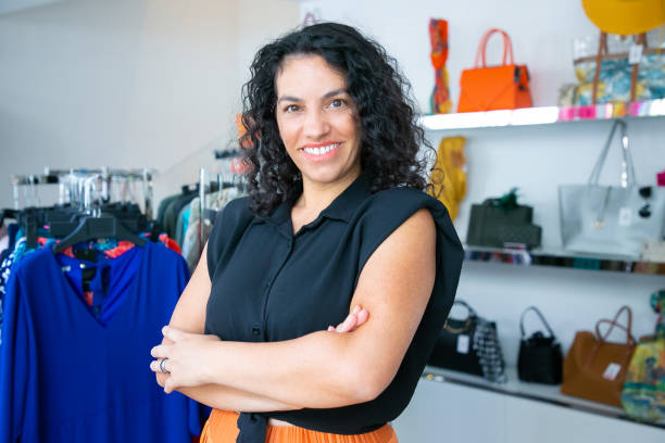 istock Joyful Latin black haired woman standing with arms folded 1279163634