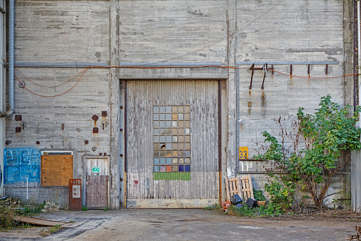 Amager, Copenhagen, Denmark, September 23, 2020: Old factory gate with graffiti in a worn down part of the city