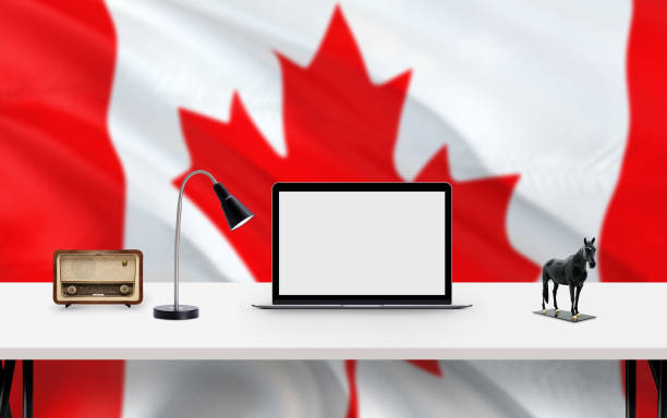 istock Canada national flag background with workspace, desktop computer and office accessories on white modern table. 1279164811