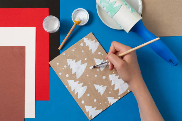 istock Child decorates craft gift bags for Christmas. Step 4 1279165762