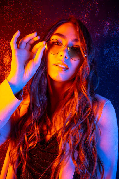 Fashion Model Girl with Glasses in Neon Lights Fashion model Girl in Neon Lights. Beautiful studio photo in colorful bright lights. Cyberpunk, Synthwave, Retrowave Art photo. vaporwave photos stock pictures, royalty-free photos & images