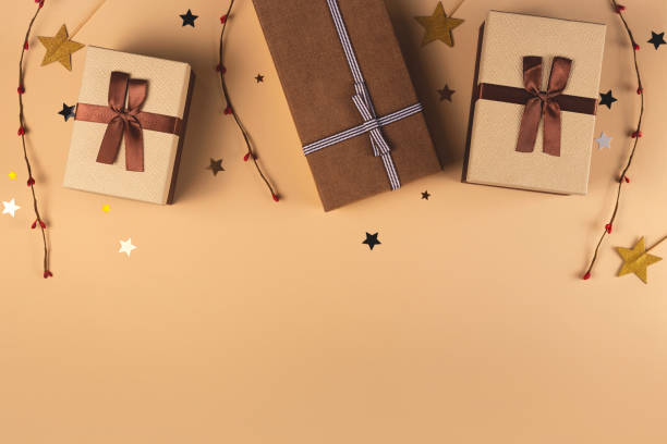 istock Three Christmas gift boxes on a neutral background among decorations 1279166356