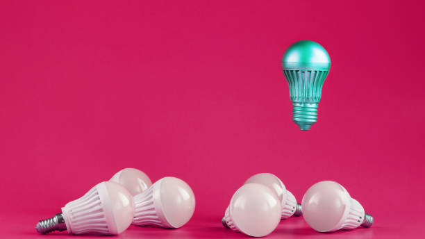 istock A special Light bulb hovers over simple, standard white light bulbs on a pink background. 1279166388